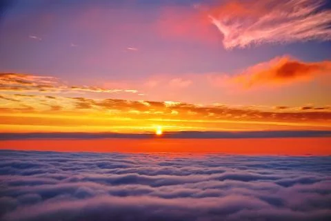 Sunset above clouds Stock Photos