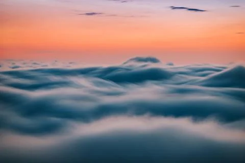 Sunset above the clouds Stock Photos