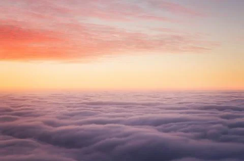 Sunset above clouds Stock Photos