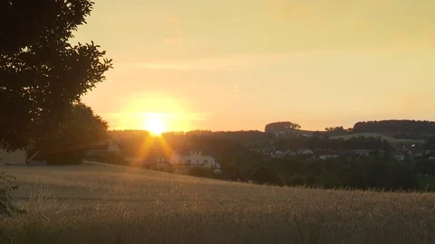 Sunset above a field in the countryside Video stock 78088917