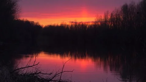 Sunset above the forest and river in spring Stock Footage 283581841