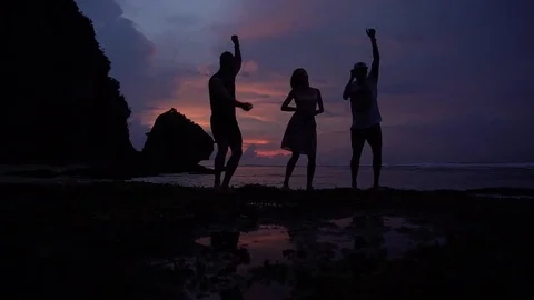 Sunset above ocean. Friends dancing and having fun Stock Footage 84843802