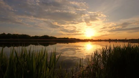Sunset above the pond with cloudy sky at summer. Stock Footage 108858436