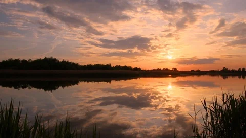 Sunset above the pond with cloudy sky at summer. Stock Footage 108858461