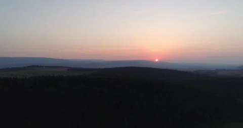 Sunset above rolling hills and forested ridges Video stock 336472868
