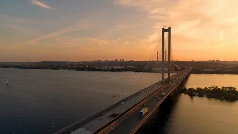 Sunset aerial of bridge over river with trucks and cars. Stock Footage 108664572
