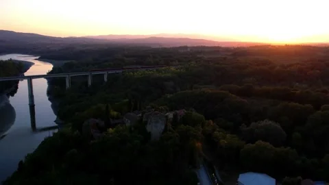 Sunset Aerial drone pan Arno river railine video bridge train passes by Tusc Stock-Footage 250094046