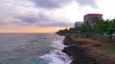 Sunset Aerial Drone View Flying Forward along Rocky Coastline at Santo Domingo Видео 345044365
