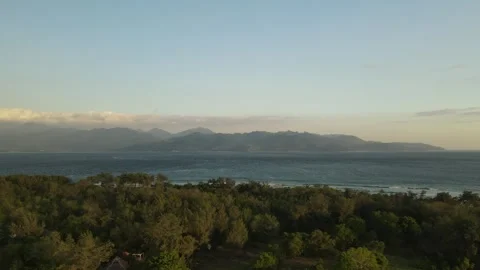 Sunset aerial flight over palm trees to the sea and mountains Stock Footage 261642747