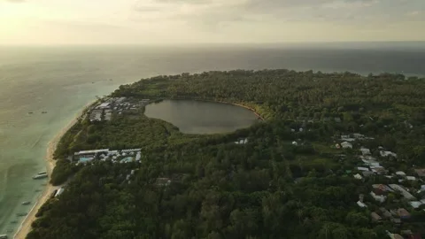 Sunset aerial flight over palm trees to the lake and mountains Stock Footage 261643546