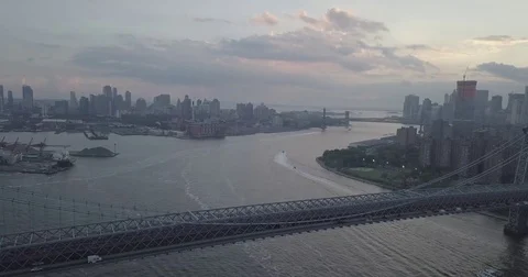 Sunset aerial over the williamsburg bridge east river  Stock Footage 84129931