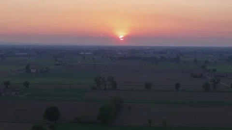 Sunset aerial pullback above agricultural fields in the Po Valley countryside Stock-Footage 336366788