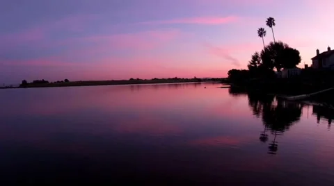 Sunset Aerial with Red Sky Over Bay and Palm Trees Video stock 37668361
