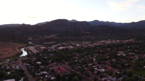 Sunset aerial of US 160 highway and neighborhoods in Durango Colorado with river Stock Footage 342479196