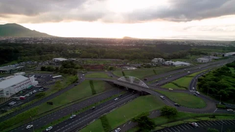 Sunset aerial view of Bagatelle Bridge in Mauritius, with traffic and lush Stock Footage 266384779