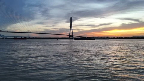 Sunset aerial view of cable stayed bridge over wide river in China Stock Footage 337885202