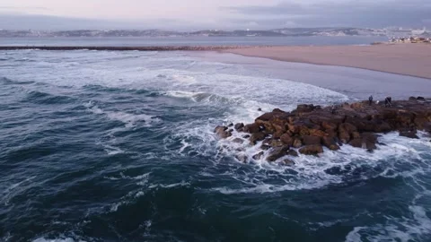 Sunset Aerial View at Cova do Vapor beach, Portugal with fishermen fishing Stock Footage 145560891