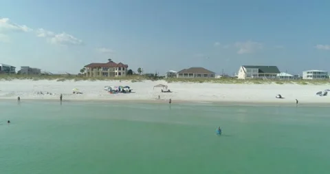 Sunset Aerial View of homes on the Ocean with White Sand Beach Stock Footage 154651554