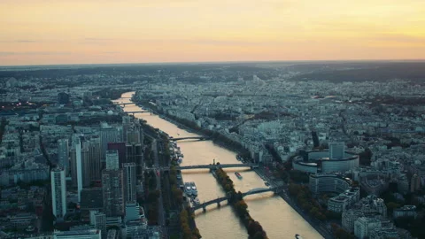 Sunset aerial view of Paris with a river, bridges, and buildings stretching Видео 313455347