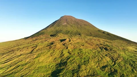 Sunset aerial view of Pico mountain (stratovolcano) against blue sky in Azores Stock Footage 300604122