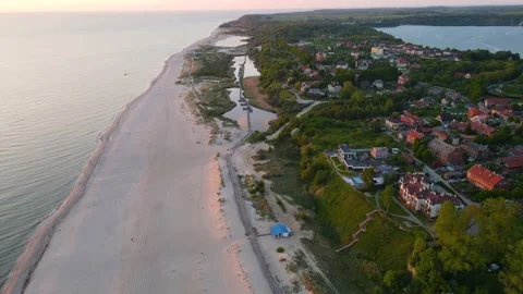 Sunset aerial view of sandy beach on the sea coast, lakes, town and forest Stock Footage 155809182