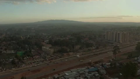 Sunset aerial view of slum, middle class flats, highway and ngong hills. Nairobi Stock Footage 148203976