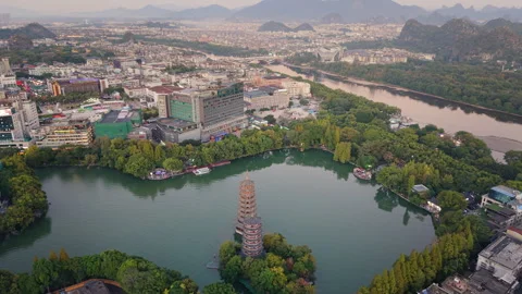 Sunset aerial view of Sun and Moon Twin Pagodas at Shanhu Lake, Guilin, China Stock Footage 330444866