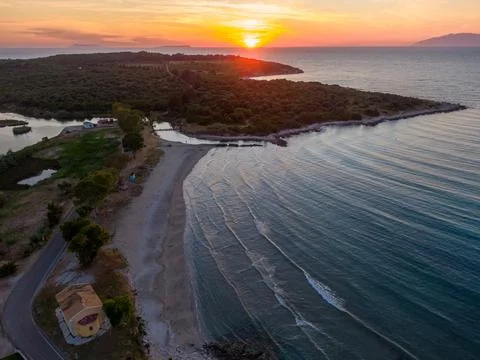 Sunset aerial view of a tranquil beach and coastline. Stock Photos