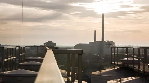 Sunset against the backdrop of an industrial city.  Stock Footage 88997640
