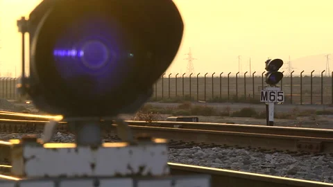 Sunset against the background of a traffic light on the railway Stock Footage 233192431