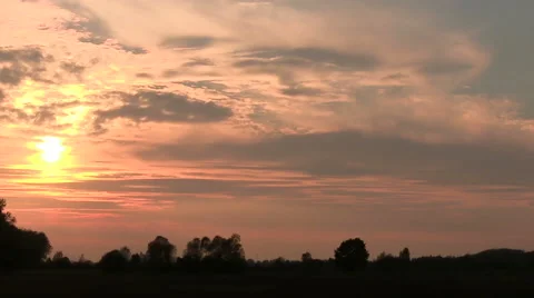 Sunset  against trees. PAL Time lapse Stock Footage 44330860