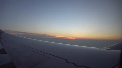 Sunset from the airplane window. View of the orange sun, aircraft wing, dark sky 스톡 동영상 106966613