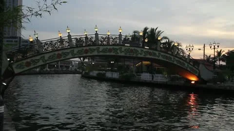 Sunset along Melaka River with view of Bridge in Malaysia 1080p Panning Stock Footage 10728173