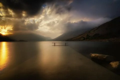 Sunset on the alpine lake Stock Photos