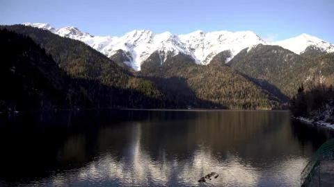 Sunset on an alpine lake Ritsa in spring. Abkhazia. Timelapse Stock Photos