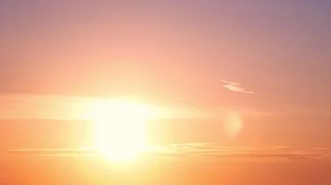 Sunset among the evening clouds. Red sun in the evening sky, timelapse Stock Photos