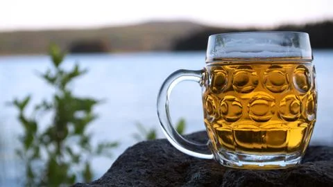 Sunset and a beer next to a lake Stock Photos