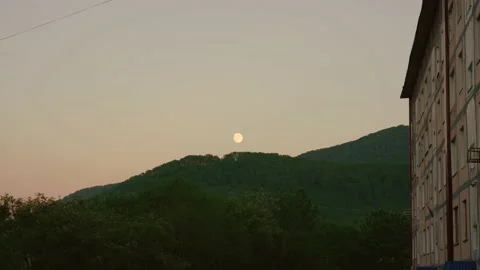 Sunset and big moon in city. Stock Footage 163564697