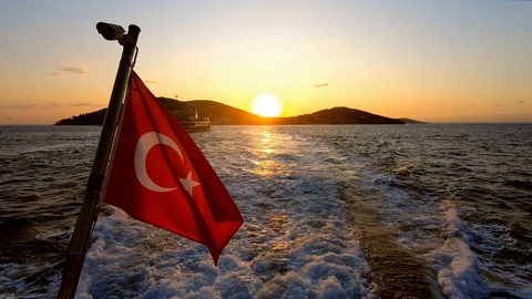 Sunset and birds accompanied by turkish flag from istanbul-islands ferry Stock Footage