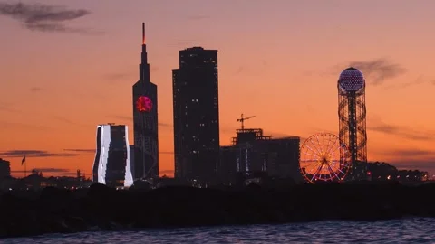 Sunset and city line with cloudy fiery orange sky Batumi, Adjara, Georgia. Video stock 276624607
