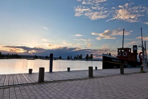 Sunset and clouds on a harbor Stock Photos