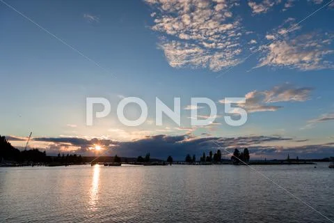 Sunset and clouds on a harbor Stock Photos