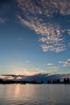 Sunset and clouds on a harbor Stock Photos