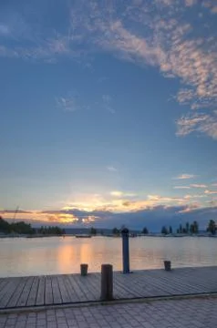 Sunset and clouds on a harbor Stock Photos