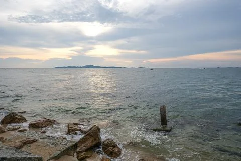 The sunset and the cloudy beach Stock Photos
