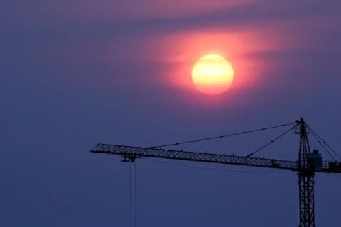 Sunset and crane Stock Photos