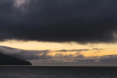 Sunset and dark clouds over the Strait of Juan de Fuca. Stock Photos