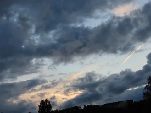 Sunset and dark clouds Stock Photos