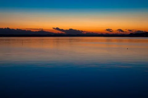 Sunset and dragon head like clouds over the lake Stock Photos