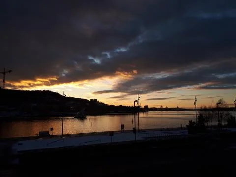 Sunset and dramatic sky over the water Stock Photos
